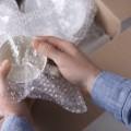 Wrapping Fragile Items in Bubble Wrap or Packing Paper